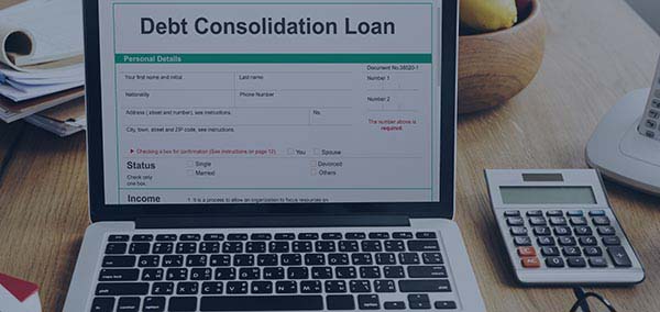 Laptop with debt consolidation loan calculator on screen
