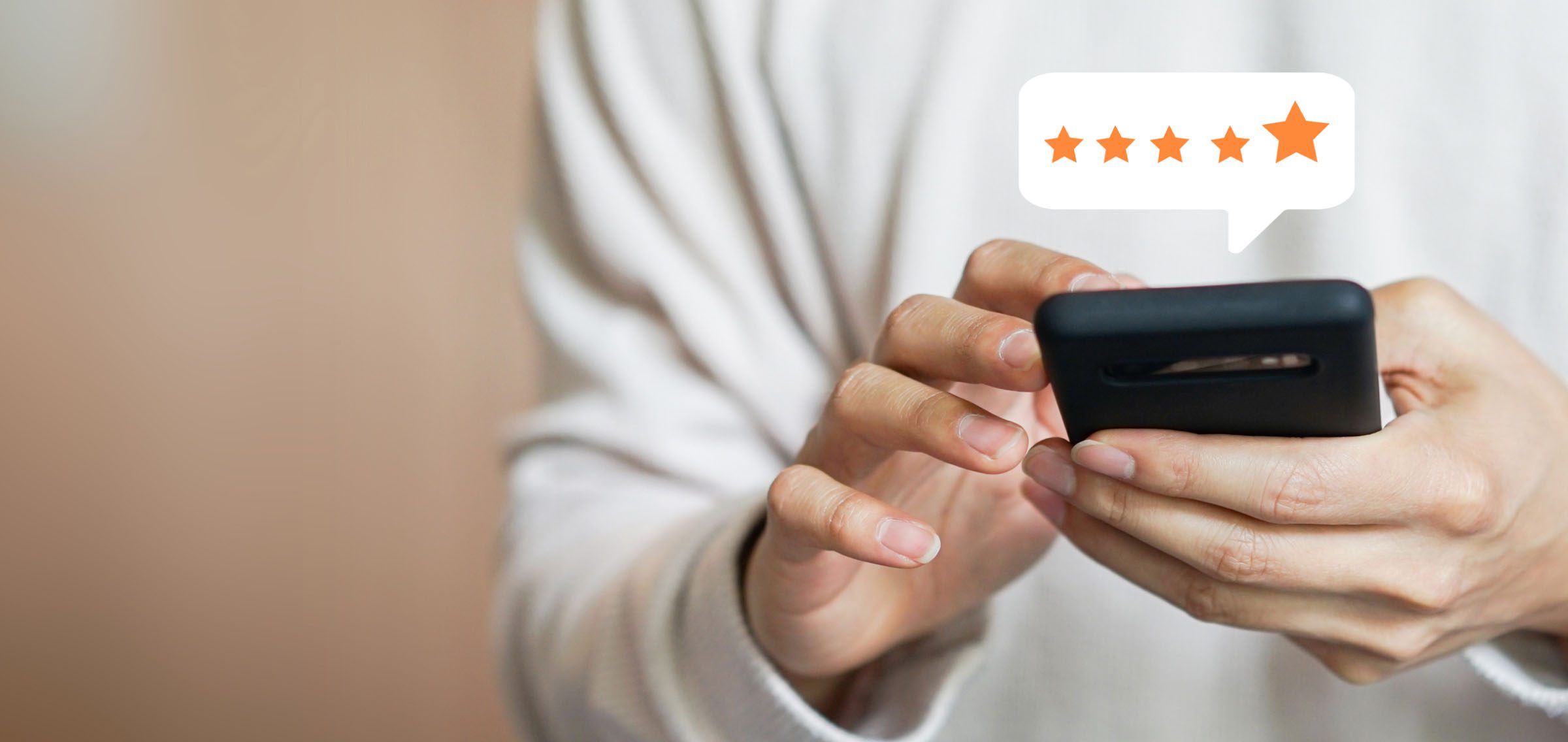 person holding phone with 5 star review pop up