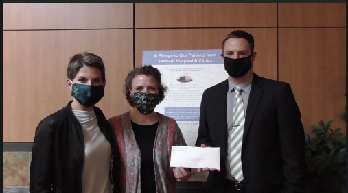 Team members present Wildfire Relief donation to Santium Hospital