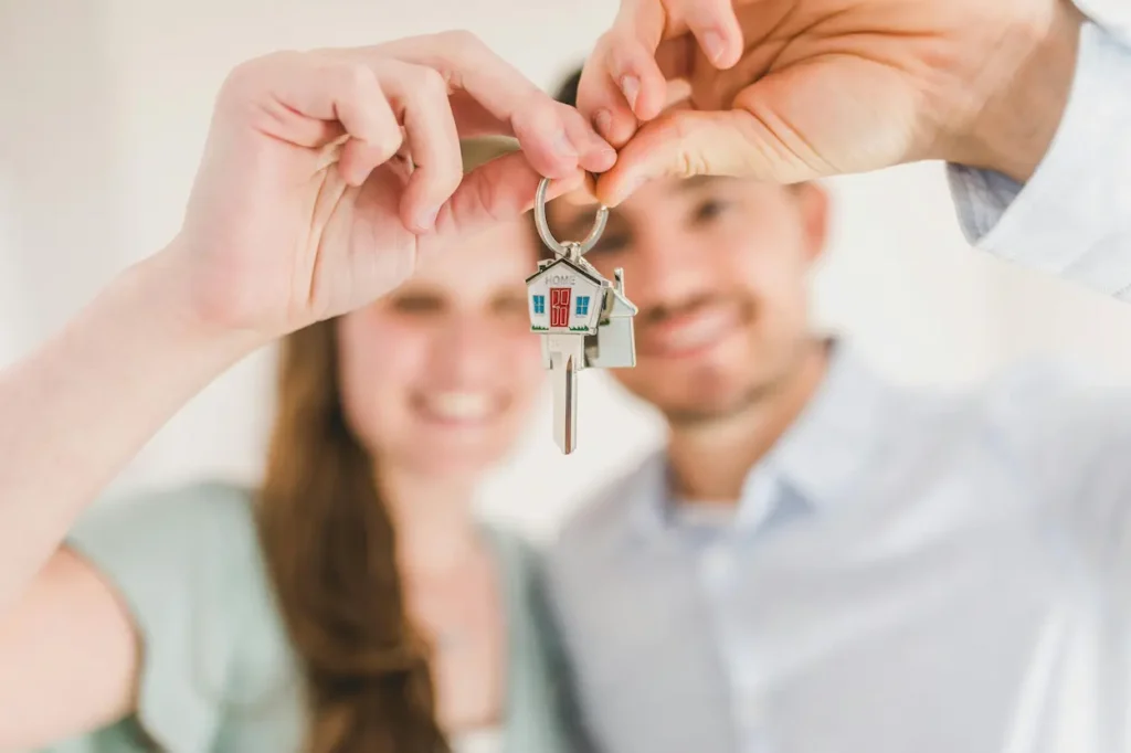 couple holding keys to new house